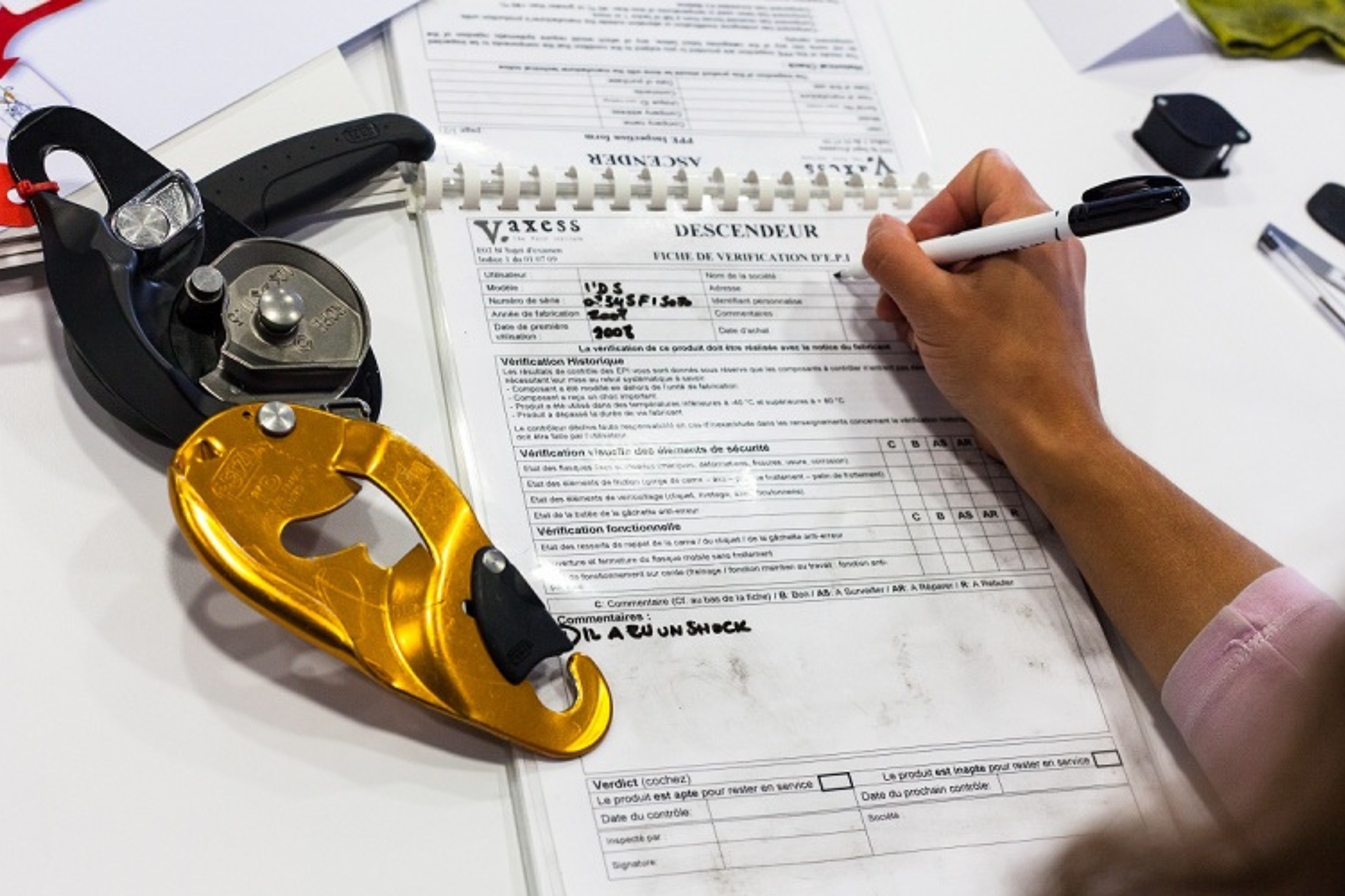 Una persona rellenando una ficha de revisión de un equipo vertical personal.